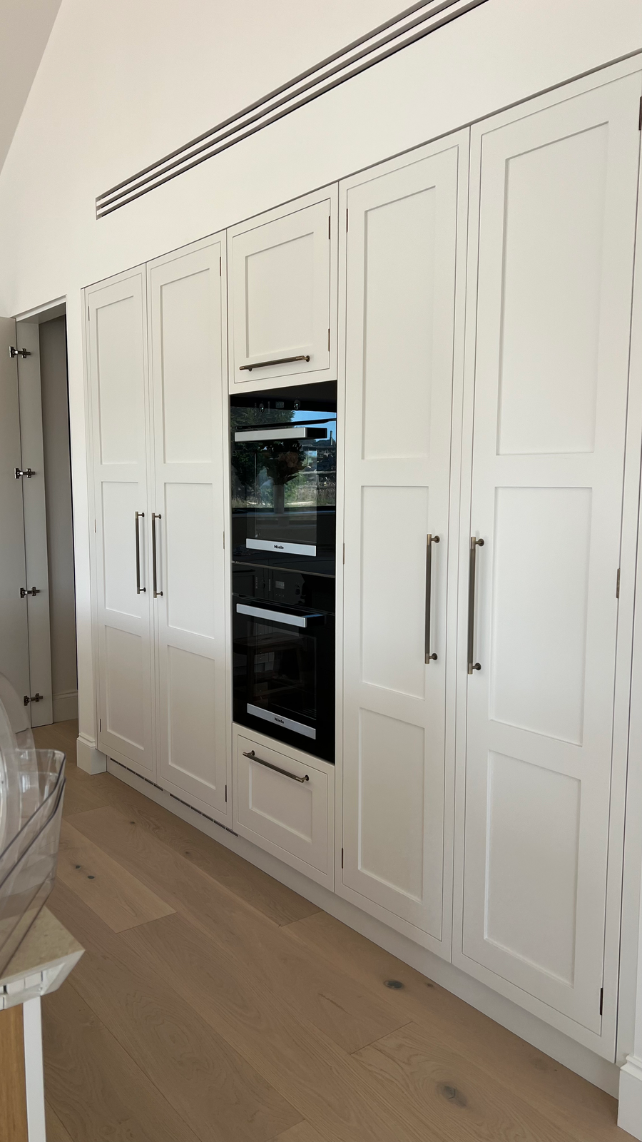White kitchen cabinets beside an oven for power hour sessions