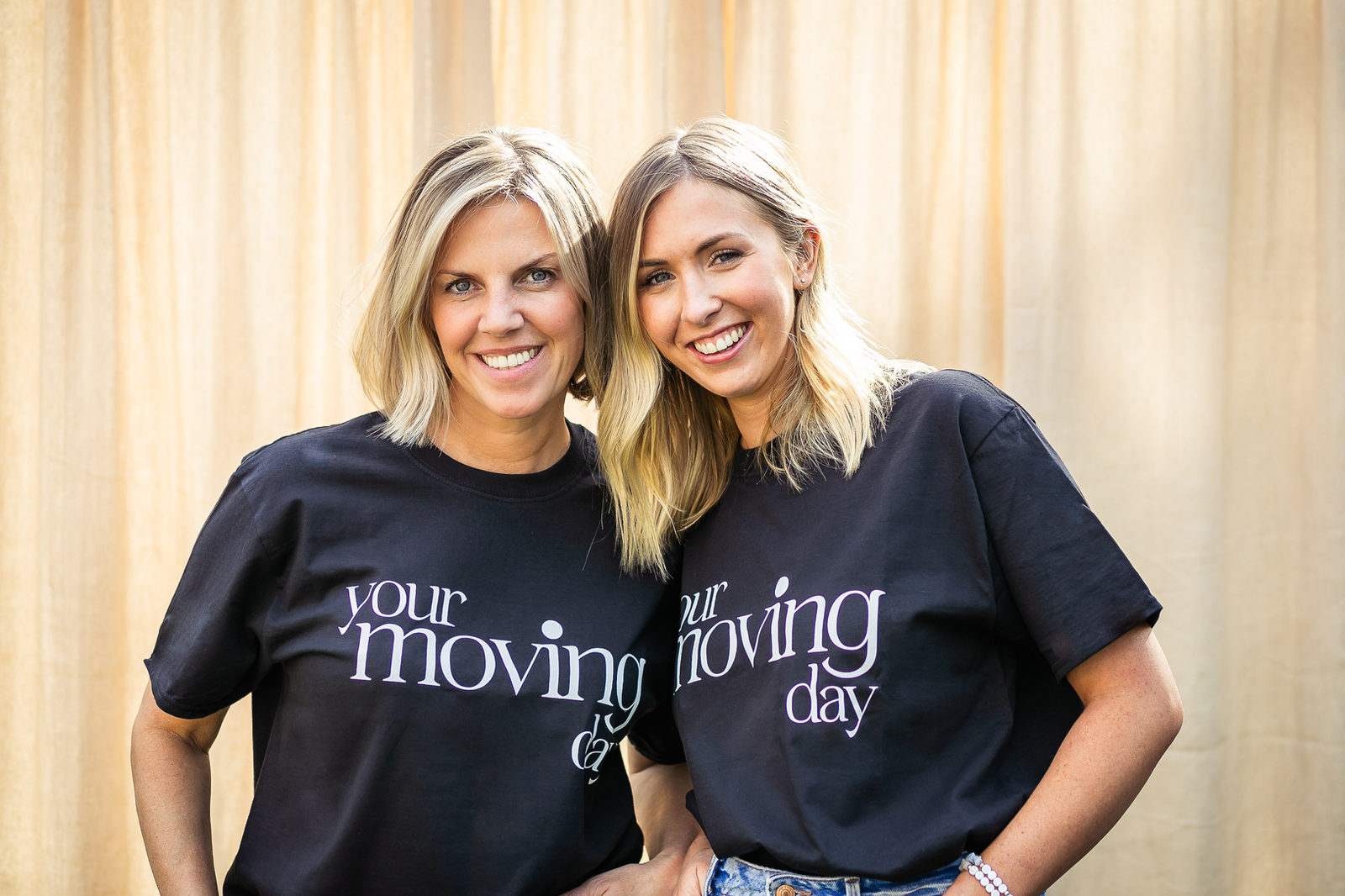 Two women in Your Moving Day shirts for moving home service.