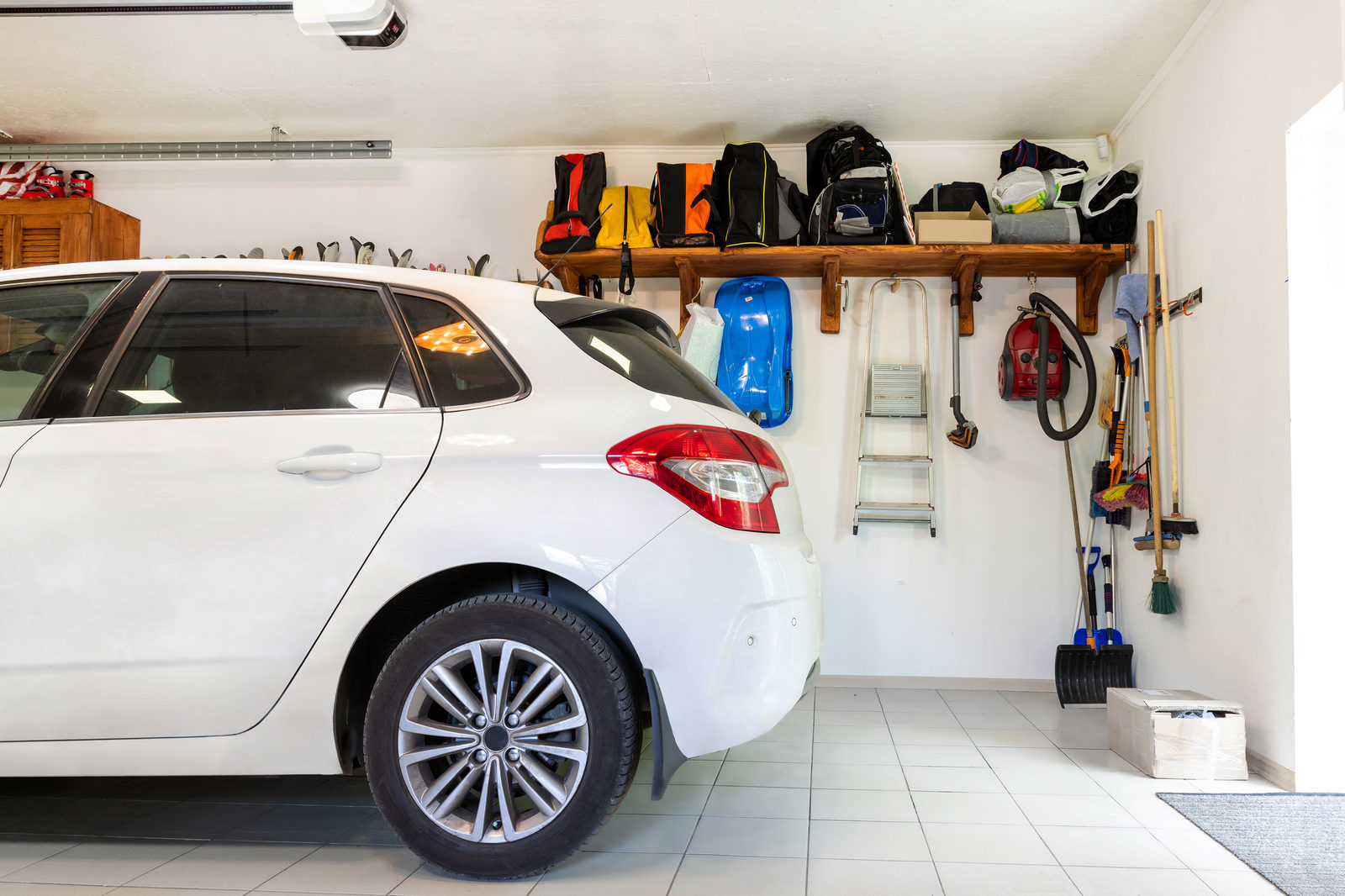 Home suburban car garage interior with wooden shelf , tools and equipment and storage